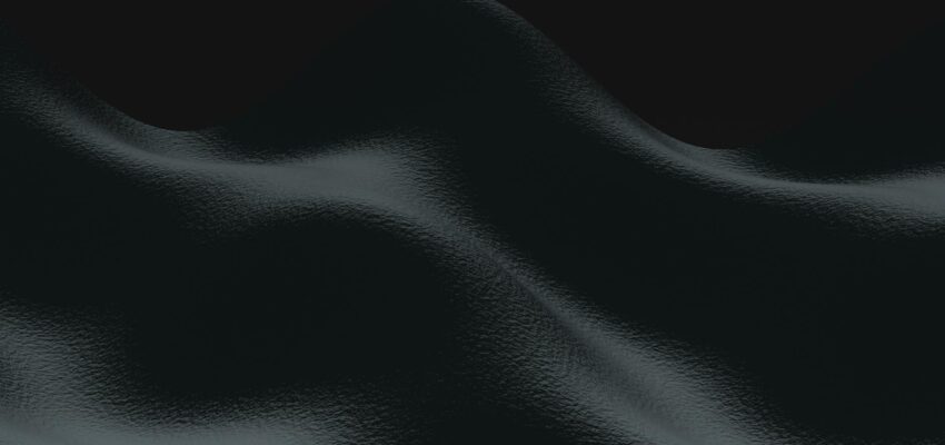 A dark abstract 3D rendering of smooth waves in a textured form.